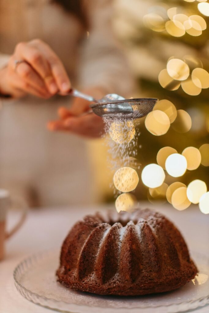 pexels-photo-6305951-6305951 Homemade chocolate chiffon cake being dusted with sugar for a festive touch.
